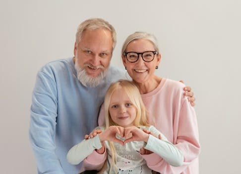 Grandparents and granddaughter share a joyful moment, symbolizing love and family unity indoors.